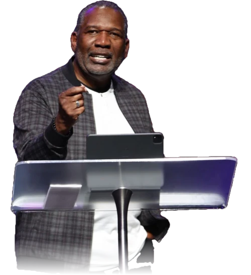 Dr. Mikel Brown speaking at a lectern
